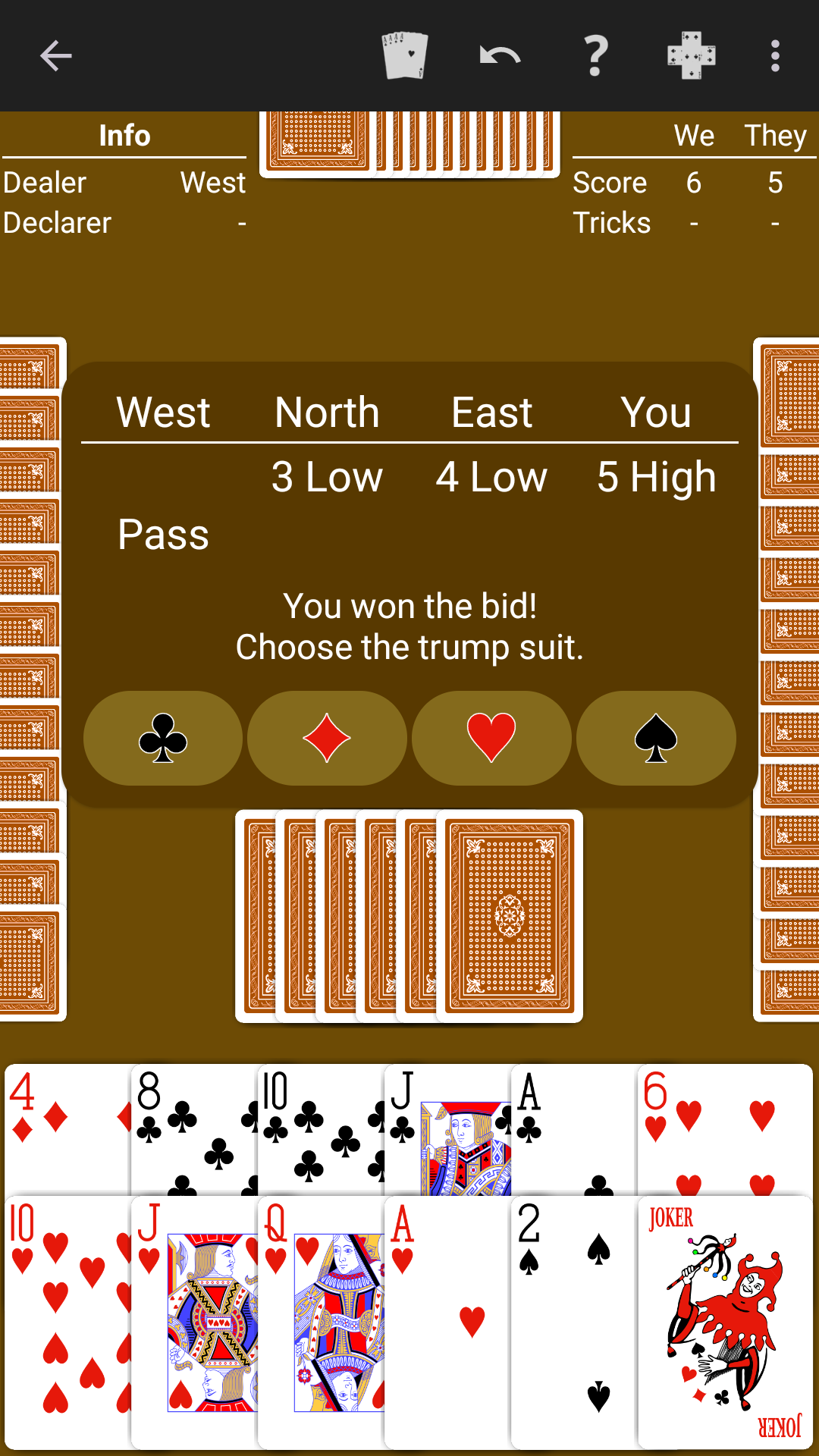 Bid Whist played on a warm brown table