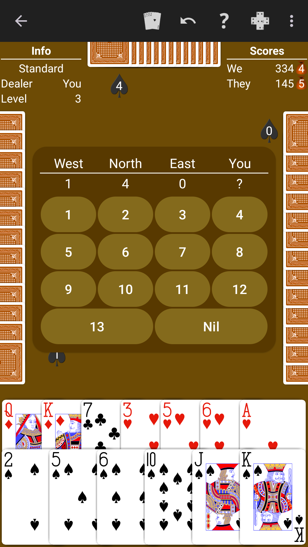 Spades played on a warm brown table